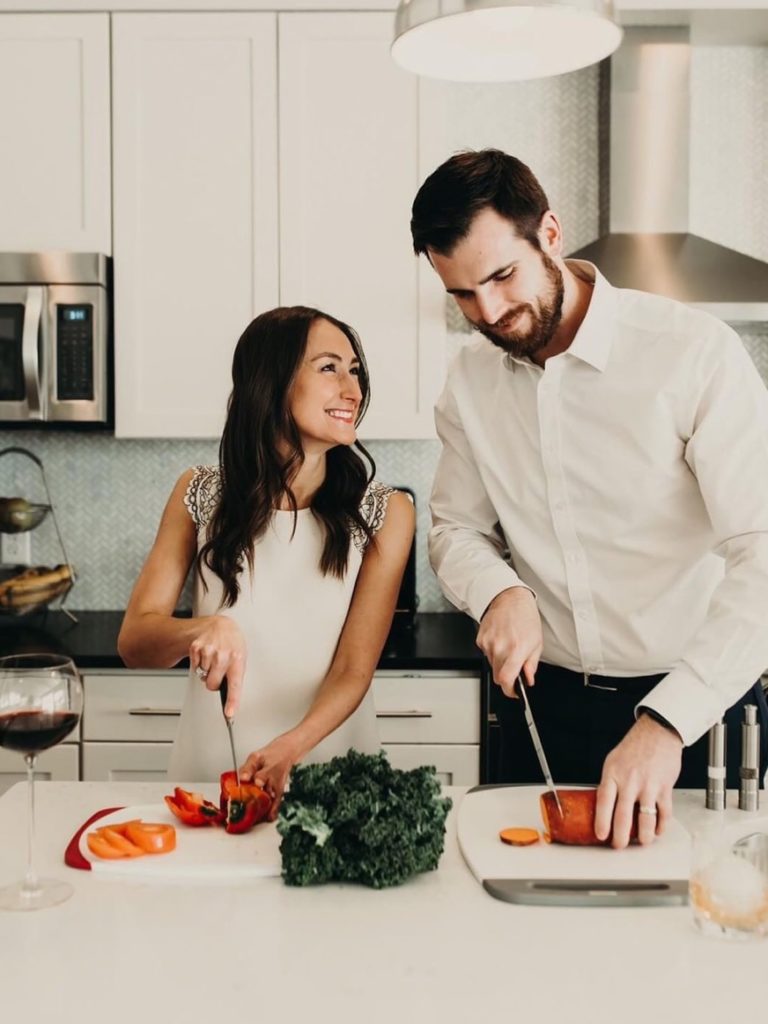 Founder and CEO Dana Spaulding with her husband, preparing a meal in the kitchen.